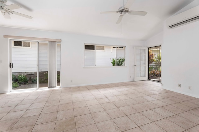 unfurnished room with an AC wall unit, vaulted ceiling, a wealth of natural light, and light tile patterned floors