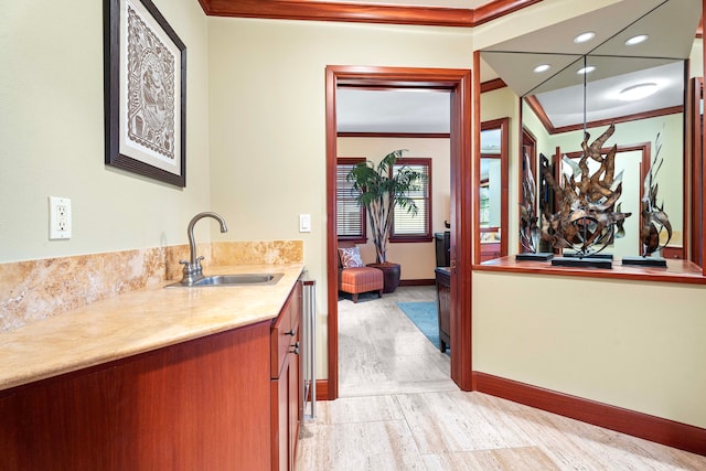 ensuite bathroom with baseboards, ornamental molding, ensuite bath, and vanity