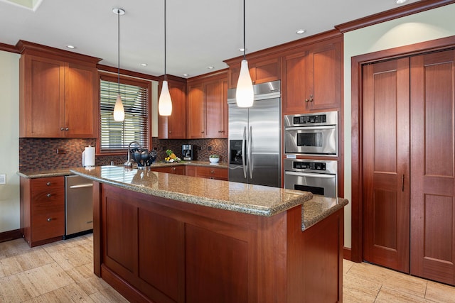 kitchen featuring a center island, stainless steel appliances, light stone countertops, and pendant lighting