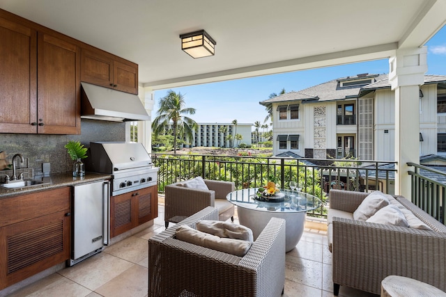 interior space with an outdoor living space, grilling area, sink, an outdoor kitchen, and a balcony