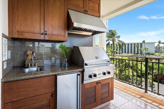 view of patio with a grill, a balcony, and sink