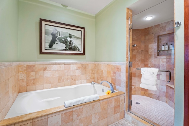 bathroom with a garden tub, a stall shower, and tile patterned flooring