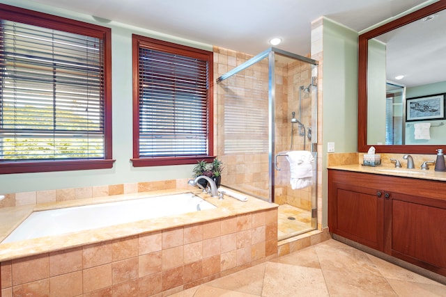 full bathroom with tile patterned floors, a shower stall, a garden tub, and vanity