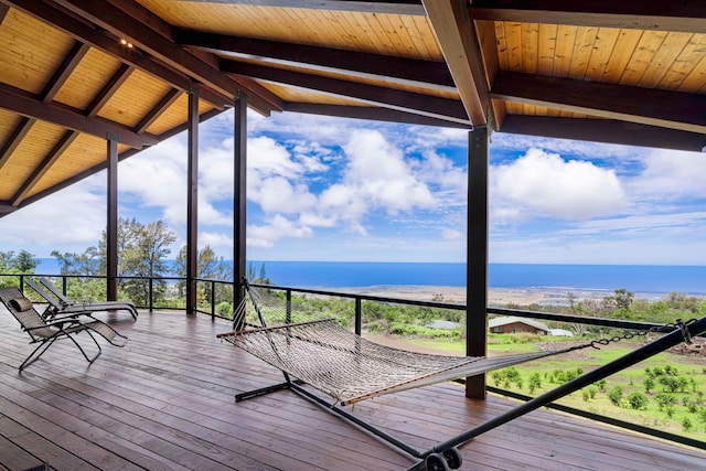 wooden terrace with a view of the beach and a water view