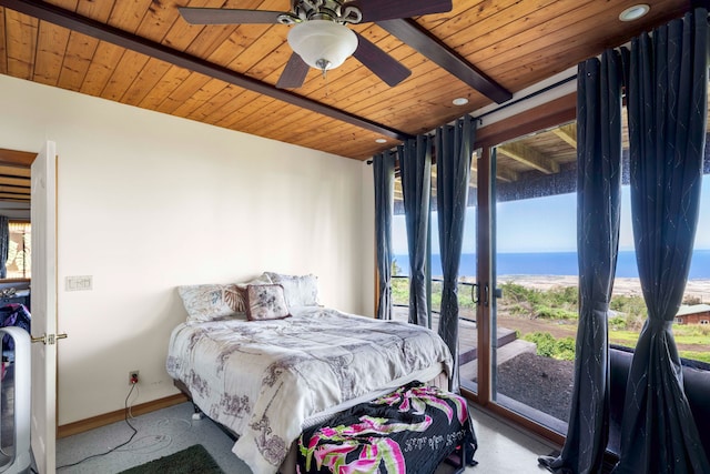 bedroom with carpet, wood ceiling, access to exterior, ceiling fan, and a water view