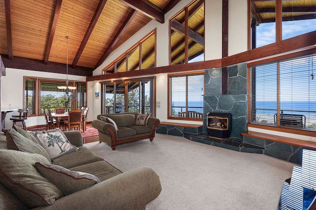 living room with a water view, high vaulted ceiling, a wood stove, and carpet