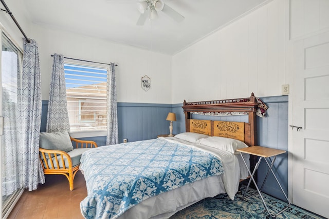 bedroom with wood-type flooring, crown molding, and ceiling fan