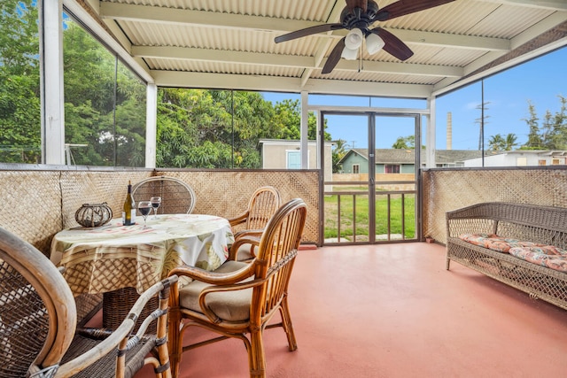 sunroom / solarium with ceiling fan and beam ceiling