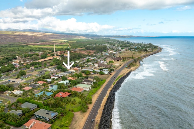 birds eye view of property featuring a water view and a beach view