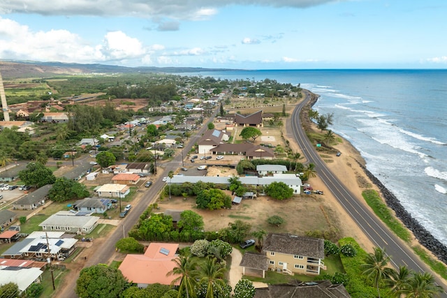 drone / aerial view with a water view and a beach view