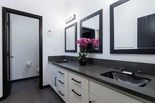 bathroom featuring toilet and vanity