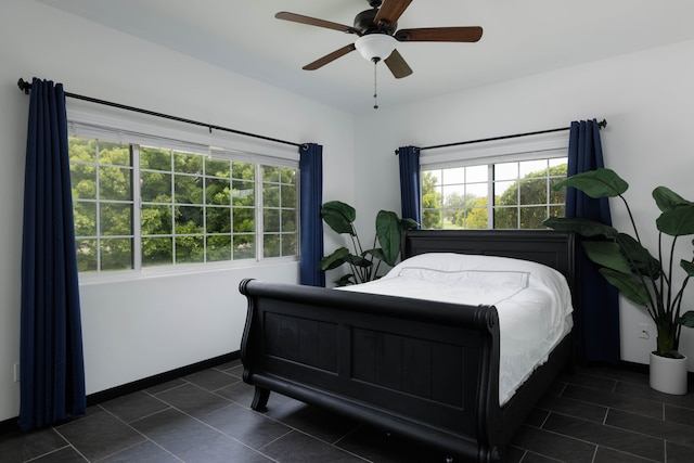 tiled bedroom featuring ceiling fan