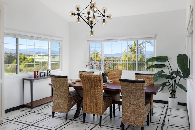 dining space featuring lofted ceiling, a mountain view, and an inviting chandelier