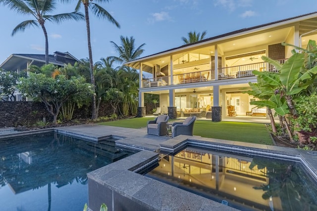 outdoor pool featuring a patio area, ceiling fan, an outdoor hot tub, and a lawn