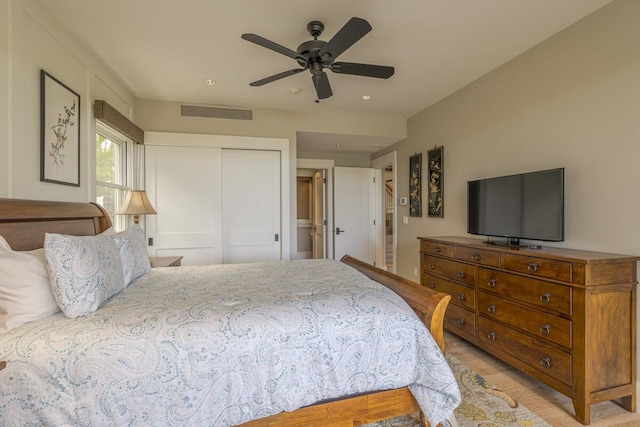 bedroom with a ceiling fan, a closet, and visible vents