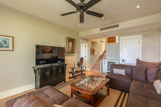 living room with light wood-type flooring and ceiling fan