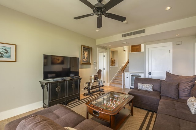 living room featuring recessed lighting, wood finished floors, a ceiling fan, visible vents, and stairway