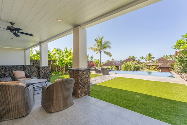 view of patio with outdoor lounge area, ceiling fan, and pool water feature