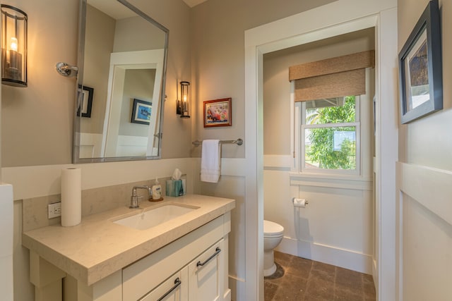 bathroom featuring vanity and toilet