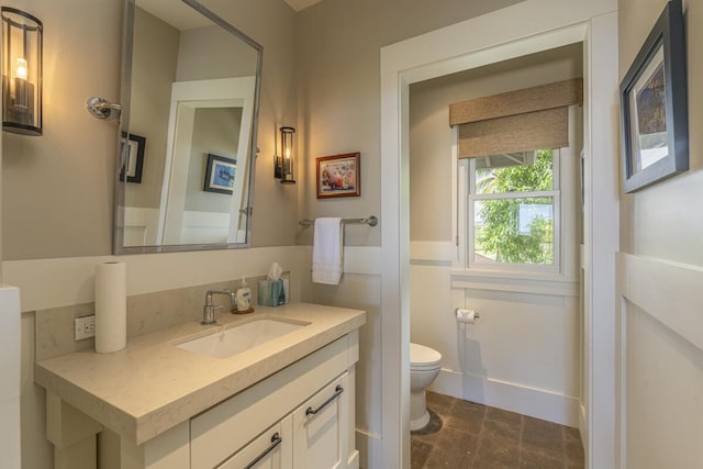 half bathroom featuring toilet and vanity