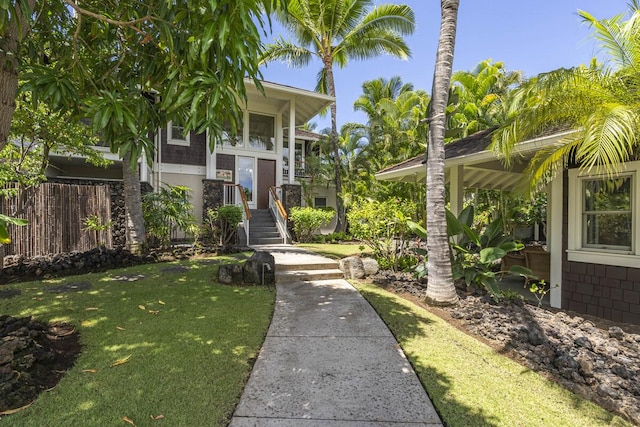 view of front facade featuring a front yard and fence