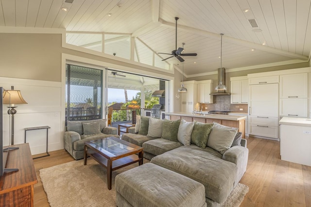 living area featuring lofted ceiling, wooden ceiling, a ceiling fan, light wood finished floors, and crown molding