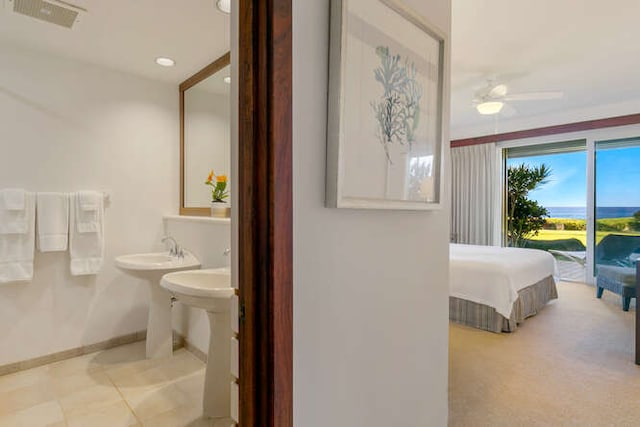 bathroom with ceiling fan and tile patterned flooring