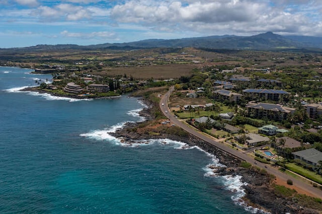 drone / aerial view with a water and mountain view