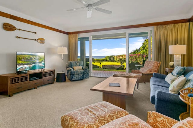 carpeted living room with ornamental molding and ceiling fan