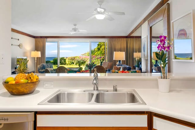 kitchen with a water view, ornamental molding, dishwasher, sink, and ceiling fan