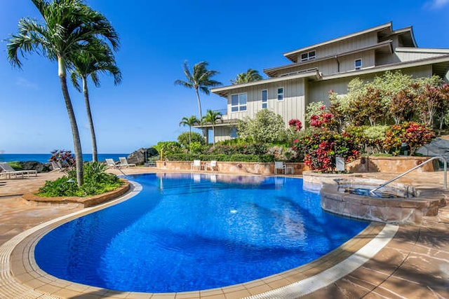 view of swimming pool with a water view