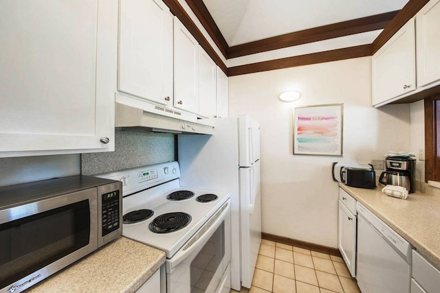 kitchen featuring white appliances, tasteful backsplash, light tile patterned floors, vaulted ceiling, and white cabinets