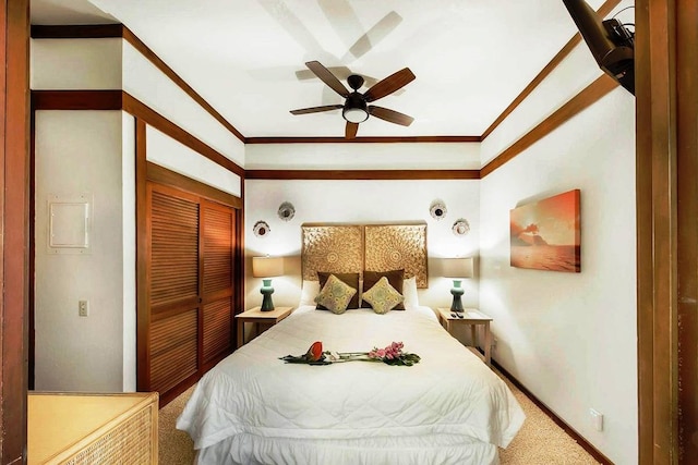 bedroom with a closet, ceiling fan, carpet, and crown molding