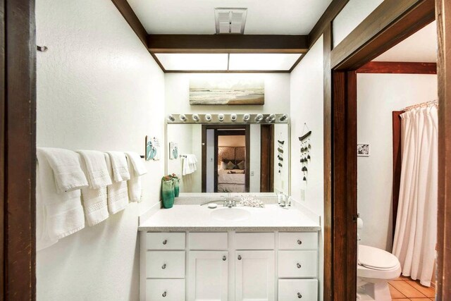 bathroom with vanity, toilet, and tile patterned floors