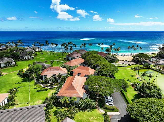 drone / aerial view featuring a beach view and a water view