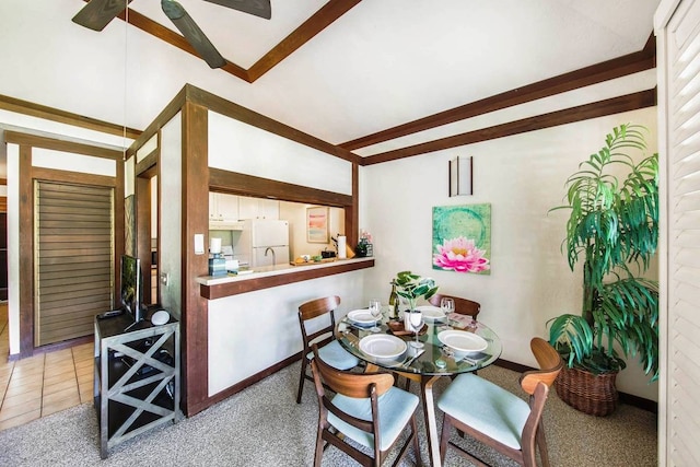 dining room with ceiling fan and carpet