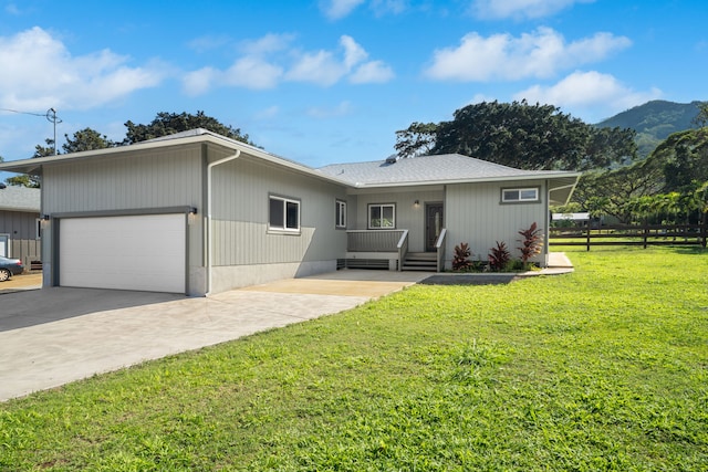 850 Kamalu Rd, Kapaa, HI 96746 - exterior space with a yard, fence, a mountain view, concrete driveway, and an attached garage