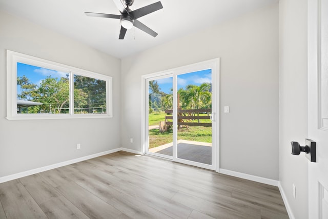 850 Kamalu Rd, Kapaa, HI 96746 - empty room with wood finished floors, plenty of natural light, and baseboards