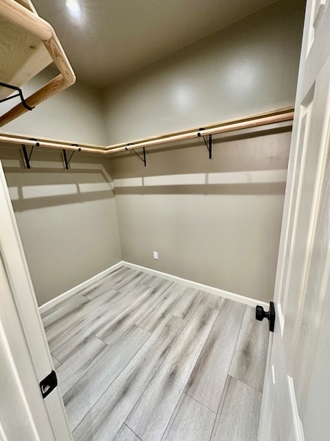 walk in closet featuring light hardwood / wood-style flooring