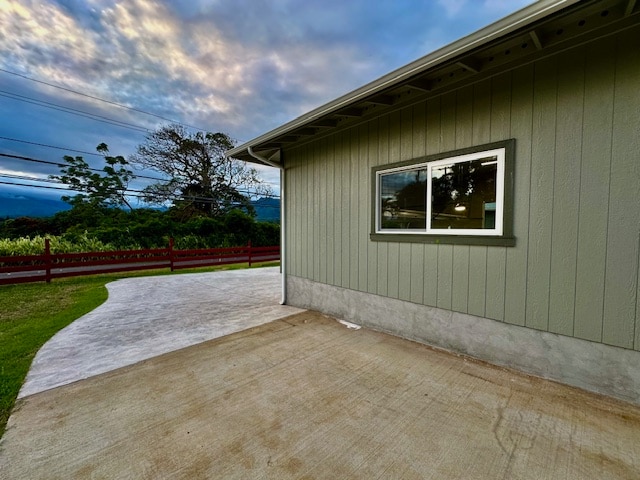 view of home's exterior featuring a patio area and fence