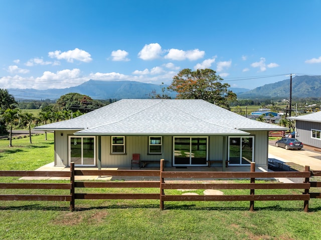850 Kamalu Rd, Kapaa, HI 96746 - back of house featuring a porch, a yard, a fenced front yard, and roof with shingles