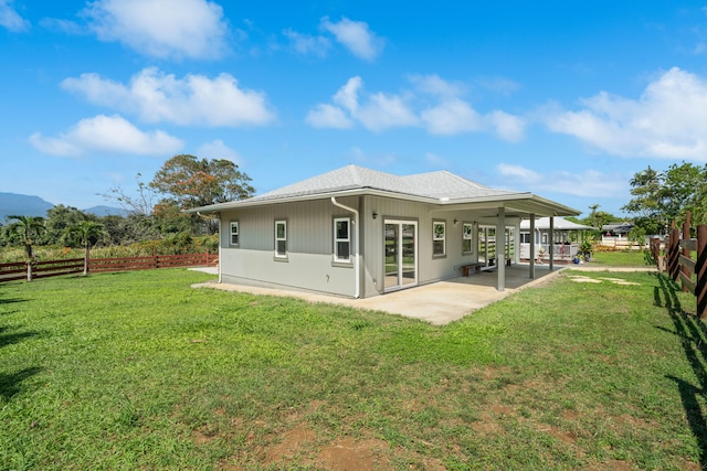 850 Kamalu Rd, Kapaa, HI 96746 - rear view of house featuring a yard, a patio, a mountain view, and a fenced backyard