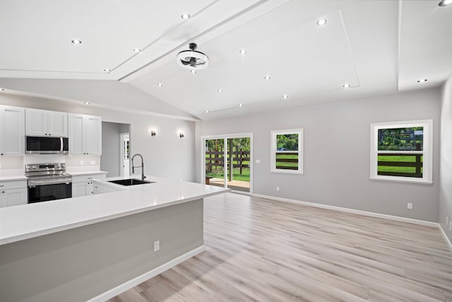 850 Kamalu Rd, Kapaa, HI 96746 - kitchen featuring a sink, light wood-type flooring, vaulted ceiling, light countertops, and appliances with stainless steel finishes