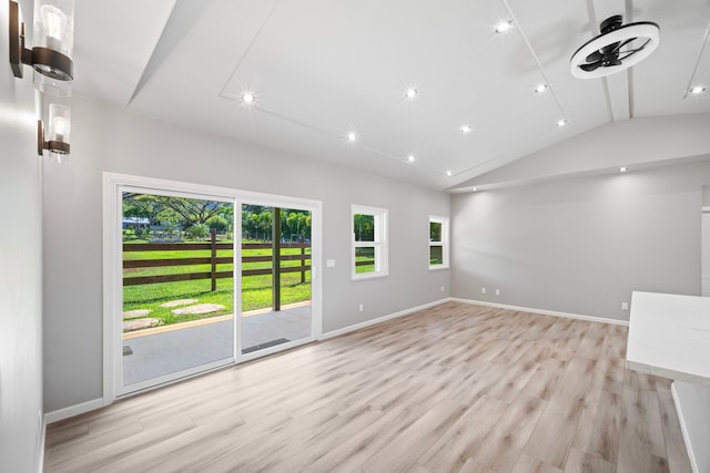 850 Kamalu Rd, Kapaa, HI 96746 - unfurnished living room featuring baseboards, vaulted ceiling, light wood-type flooring, and plenty of natural light