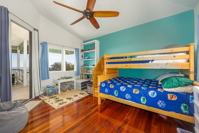 bedroom with a ceiling fan, hardwood / wood-style floors, and vaulted ceiling