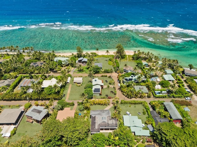 drone / aerial view featuring a water view and a view of the beach