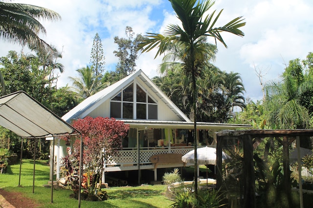 back of house featuring a yard and a wooden deck