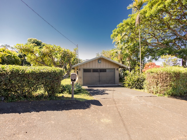 view of front of house featuring a garage and an outdoor structure