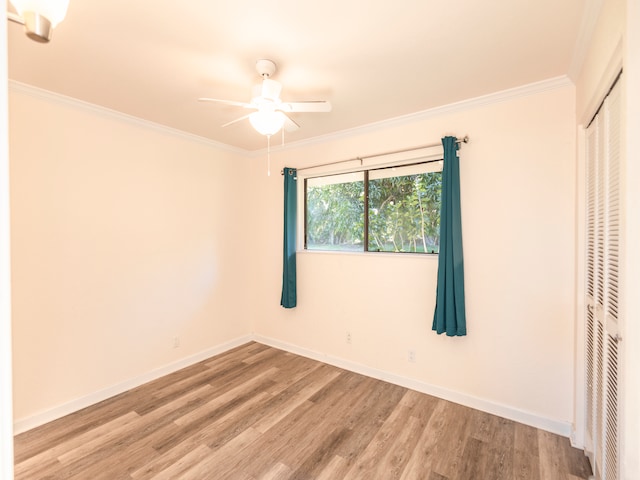 unfurnished bedroom featuring crown molding, a closet, ceiling fan, and light hardwood / wood-style floors