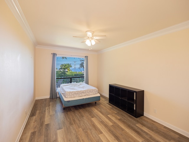 bedroom with ornamental molding, dark hardwood / wood-style flooring, and ceiling fan